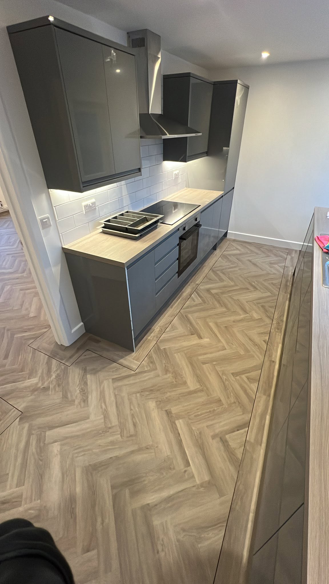 New grey kitchen with a herringbone floor