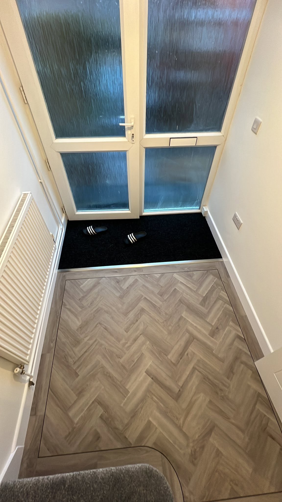 Entrance hall herringbone with an inset door mat