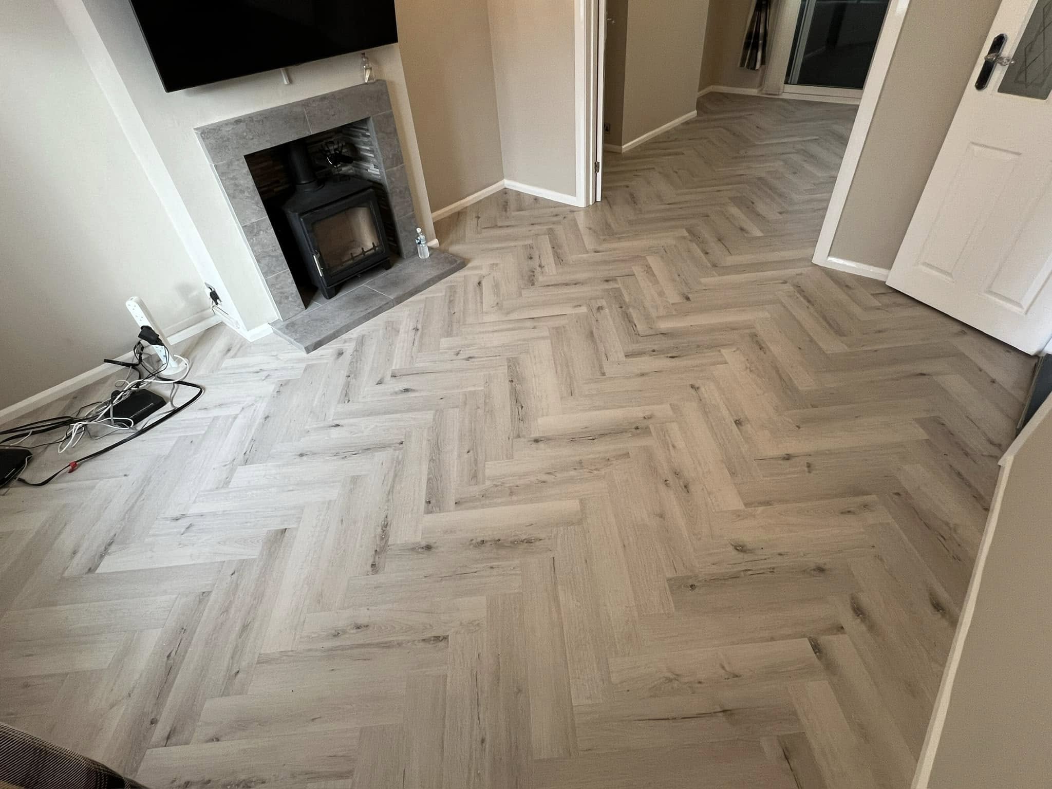 Light grey herringbone in a lounge with a wood-burning stove