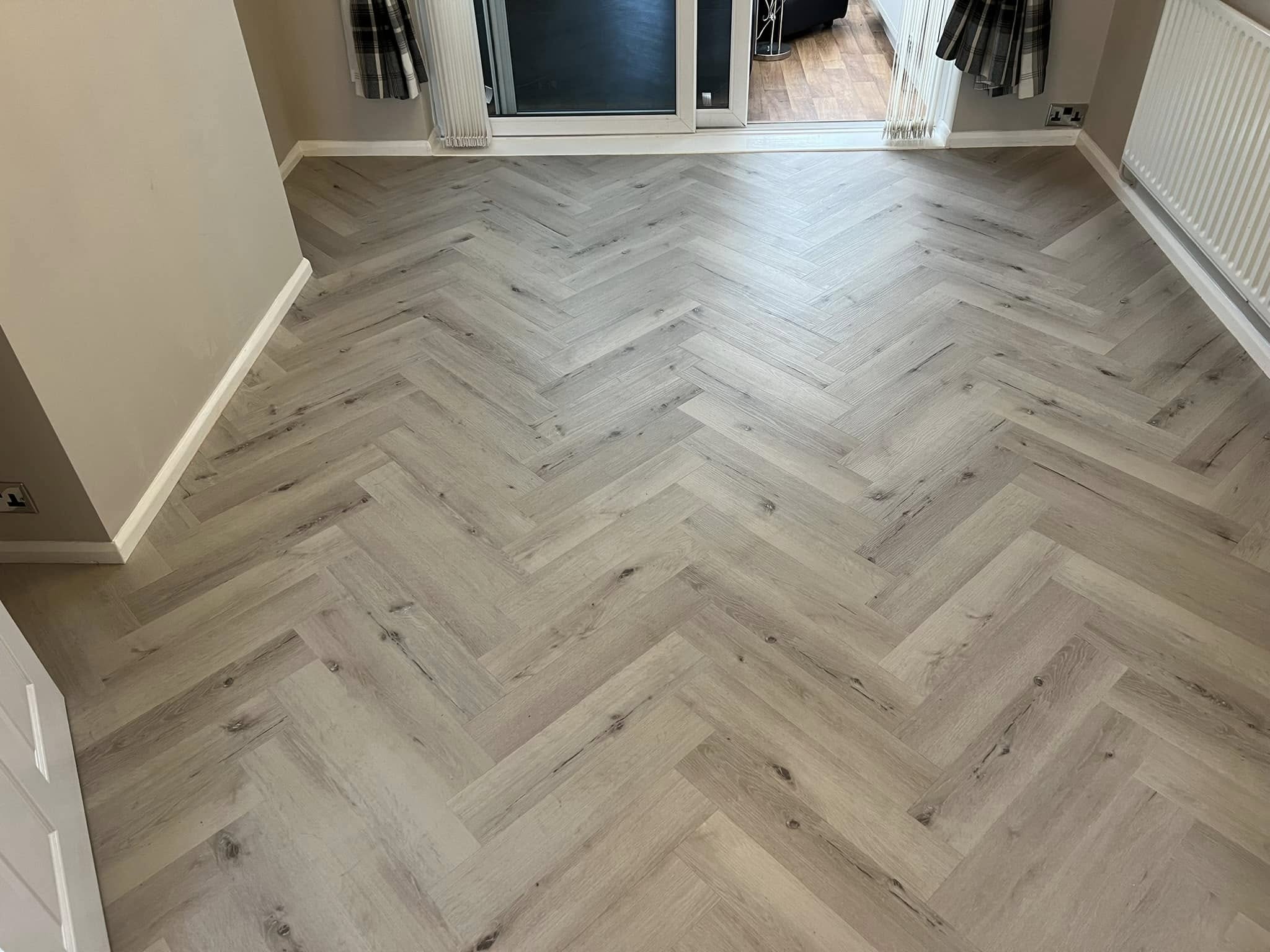 Light grey herringbone running to patio doors