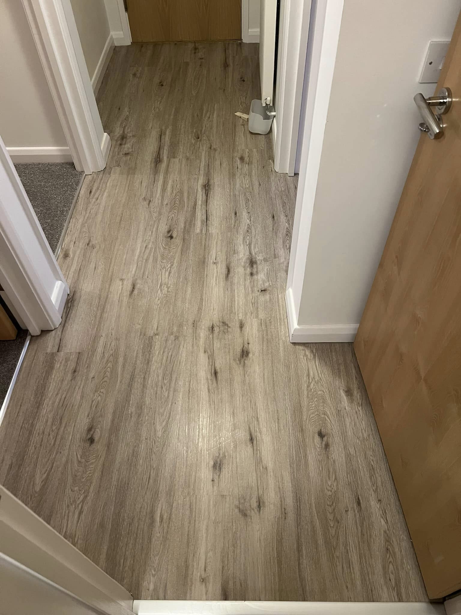 Rustic oak-effect plank floor in a hallway