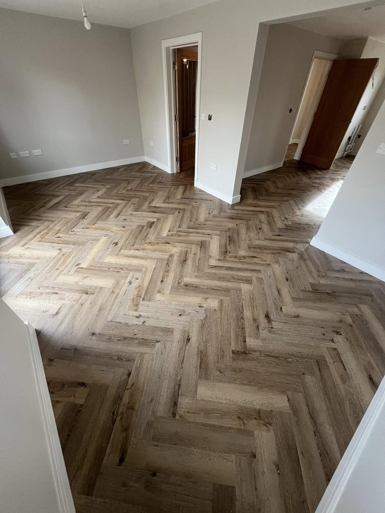 Oak herringbone floor through an open-plan space