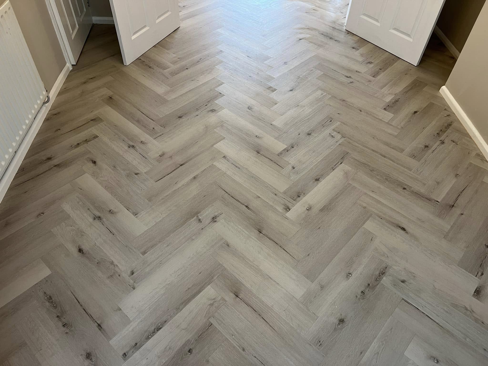 Light grey herringbone in a hall between doors