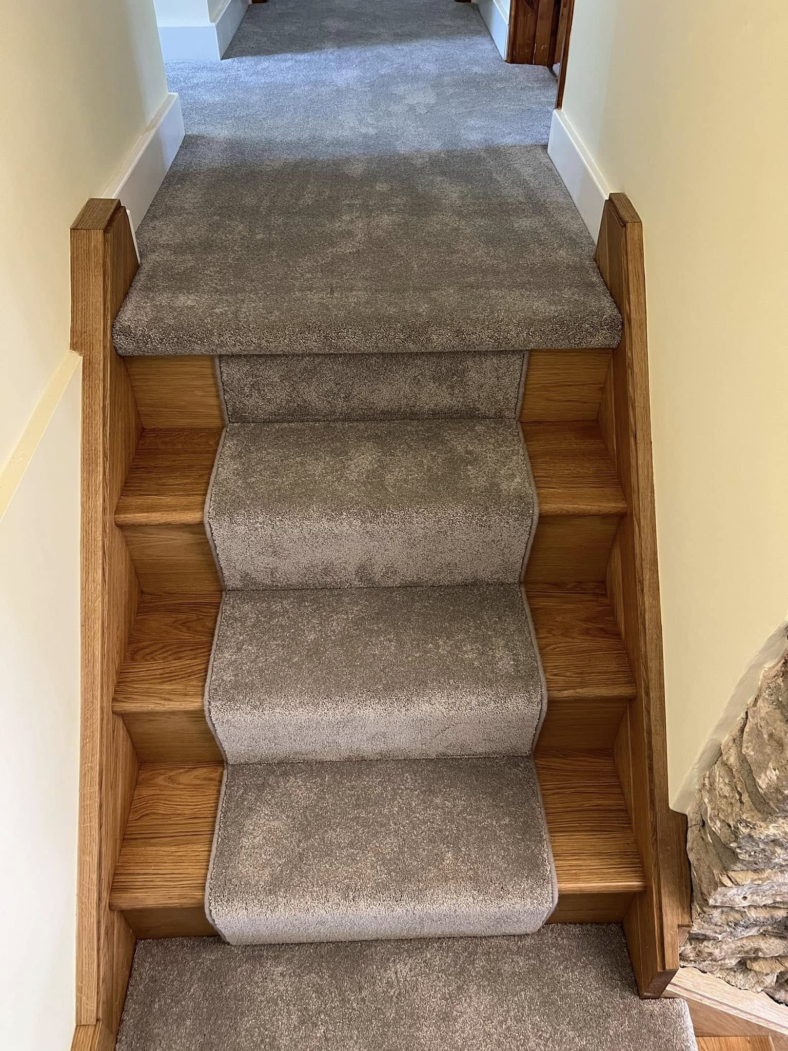 Grey stair runner on oak stairs, seen from below