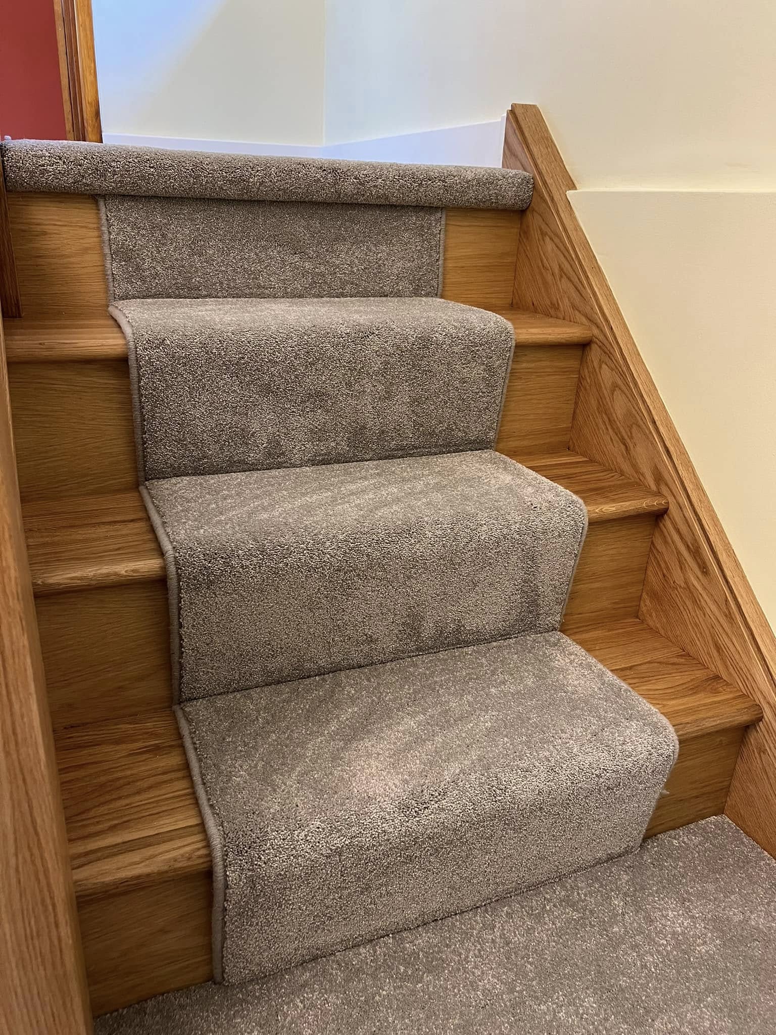 Close view of a grey stair runner on oak treads