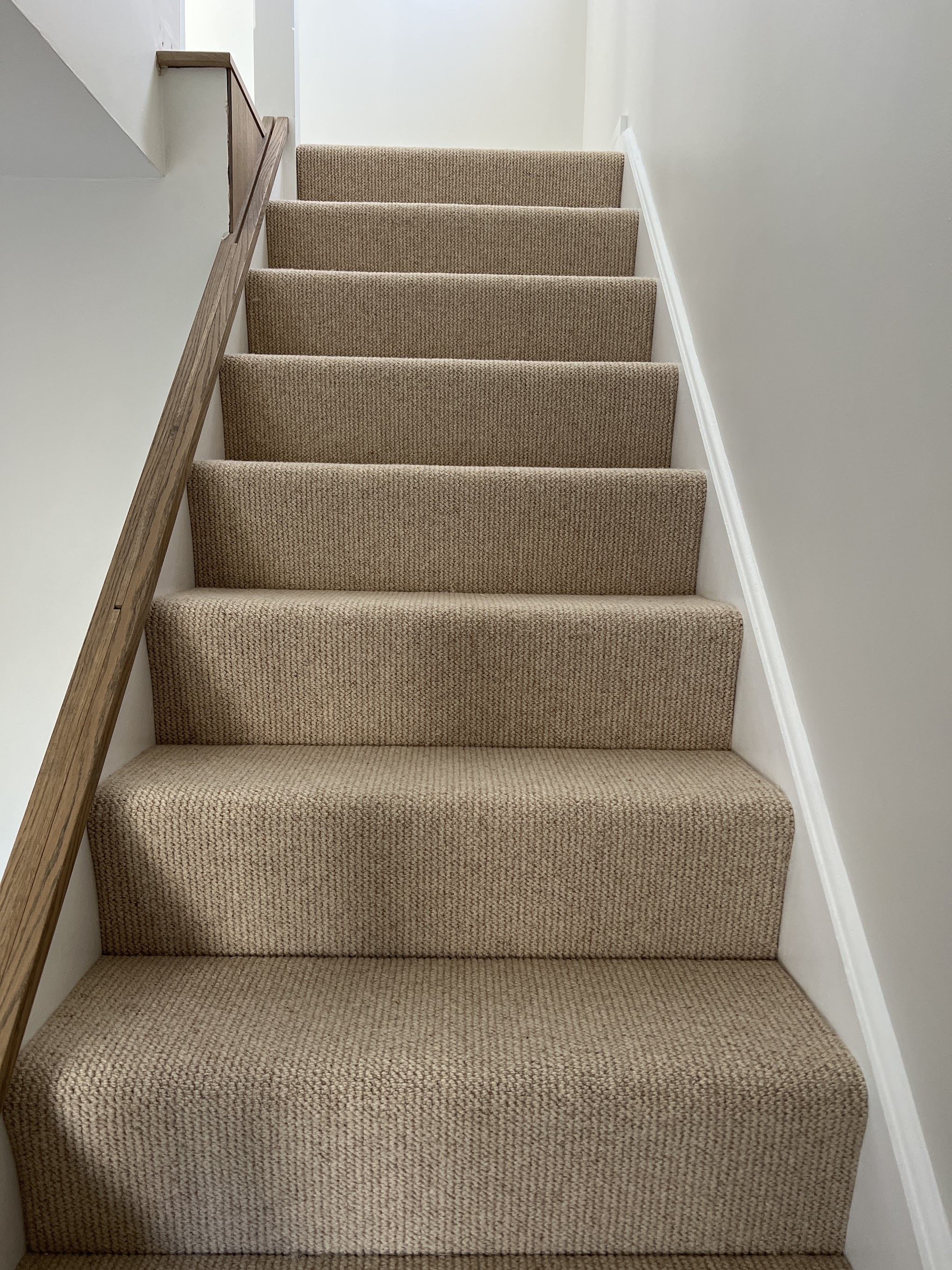 Oatmeal carpet on a straight flight of stairs