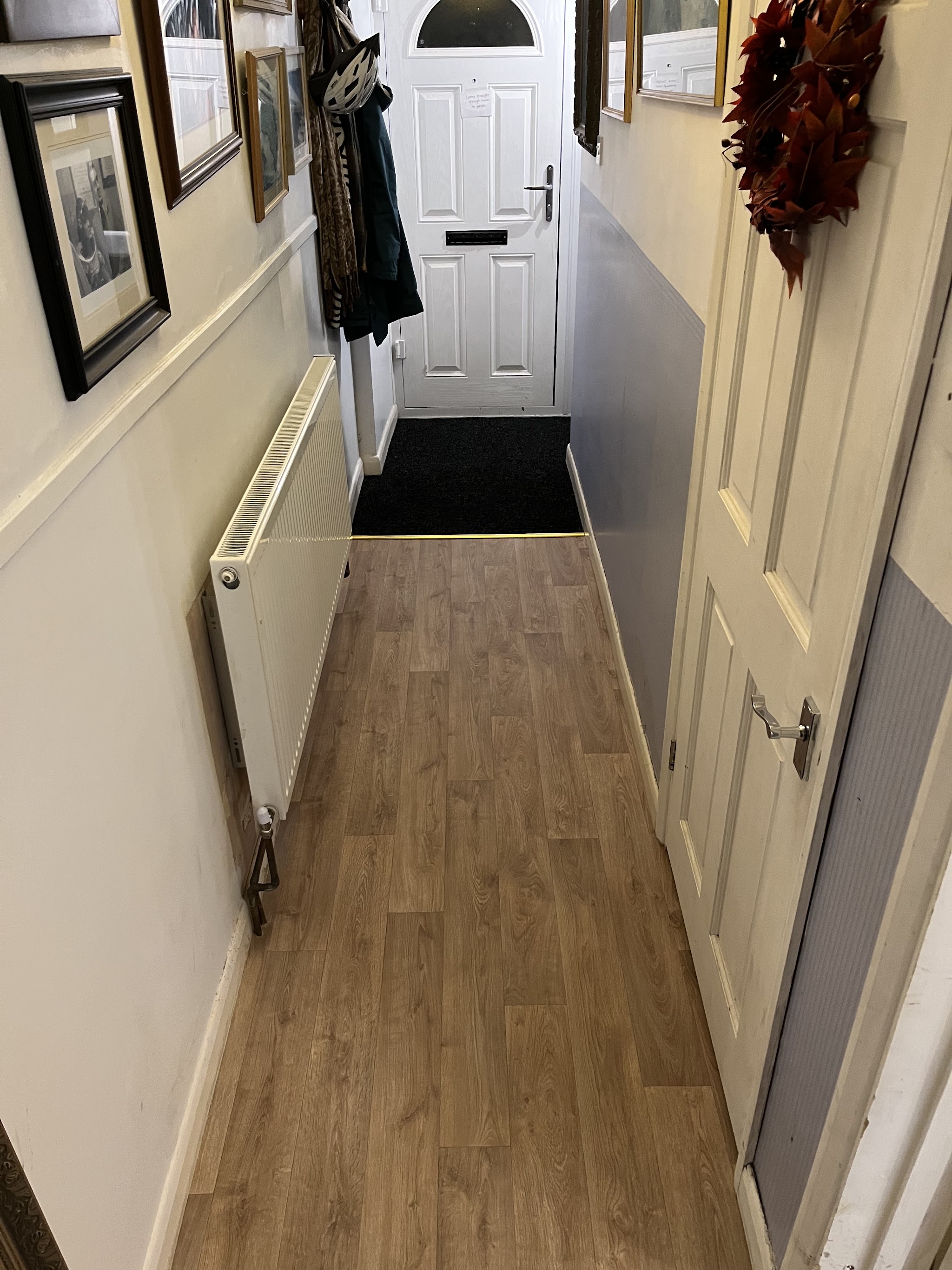 Wood-effect floor down a narrow hallway